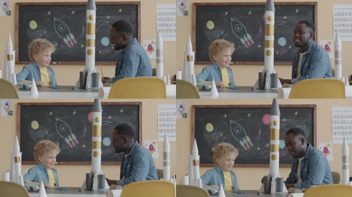 老师向小男生讲解太空火箭的构造