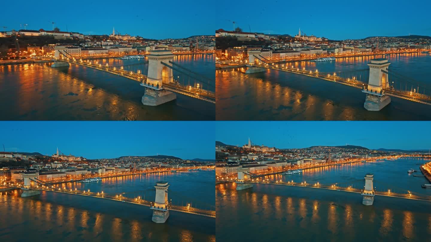 空中高角度无人机镜头照亮sz<s:1> chenyi链桥在多瑙河黄昏对晴朗的蓝天在布达佩斯，匈牙利