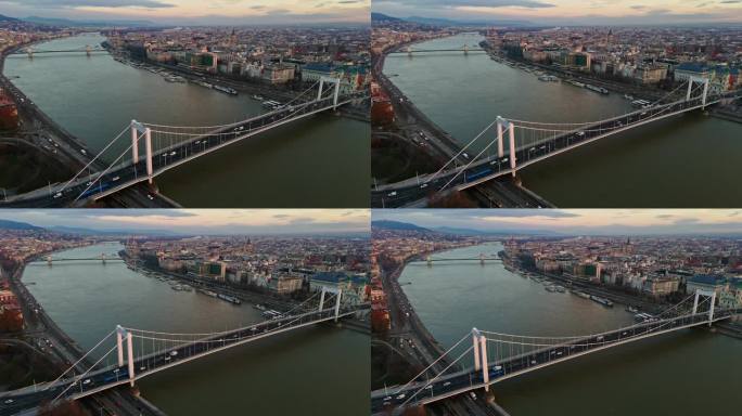空中无人机拍摄的伊丽莎白桥和sz<s:1> chenyi链桥在多瑙河上的布达佩斯城市景观在日落，匈牙