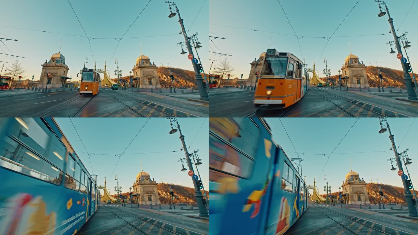 手持拍摄的有轨电车和汽车在自由桥上移动对蓝天在布达佩斯，匈牙利