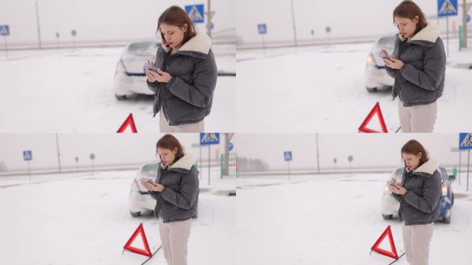 一名年轻的女司机在冬天的雪地里，在湿滑的道路上撞坏了自己的车，她在车旁边呼叫了一辆带有紧急三角标志的