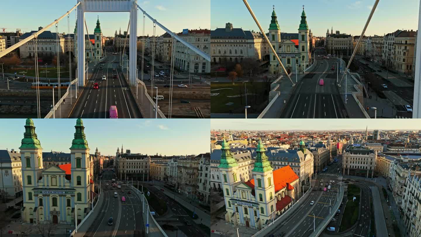 无人机拍摄的车辆行驶在伊丽莎白桥由教区教堂对天空在布达佩斯，匈牙利