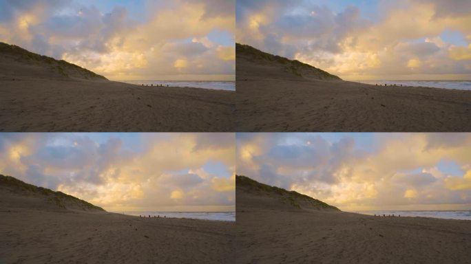 日落时分，天空下的沙滩和对比鲜明的云彩。静态照片