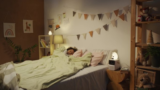 小孩睡在大双人床在舒适的装饰卧室