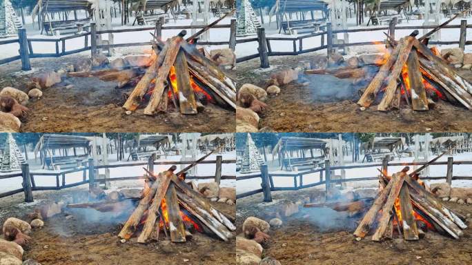 在寒冷的天气里，村子里为了取暖而生的大火的慢镜头，