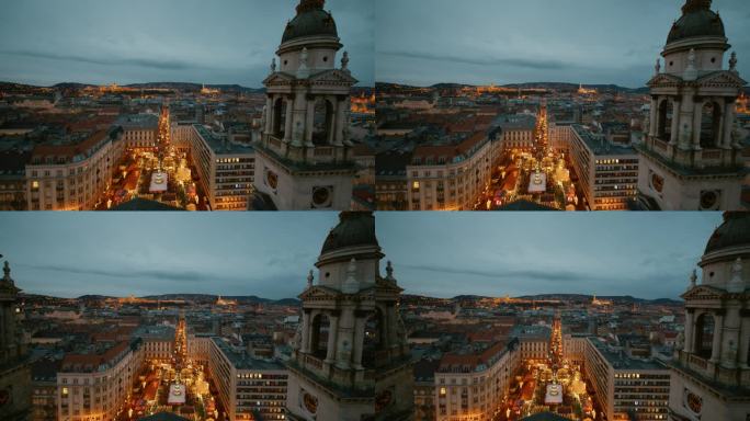圣斯蒂芬大教堂的钟楼俯瞰布达佩斯的城市景观和圣诞市场黄昏，匈牙利