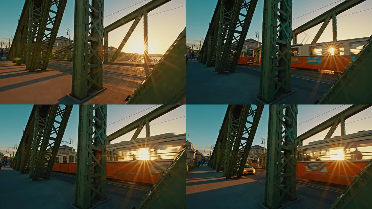 在阳光明媚的一天，匈牙利布达佩斯，有轨电车和汽车通过自由桥的手持照片
