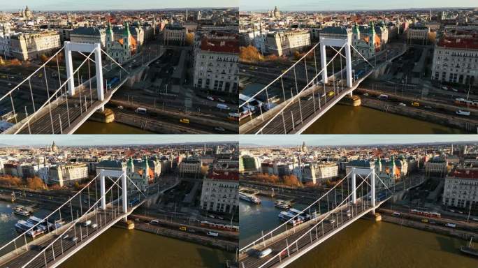 在晴朗的日子里，在匈牙利的伊丽莎白桥上俯瞰布达佩斯城市景观的车辆移动的运动模糊空中无人机镜头