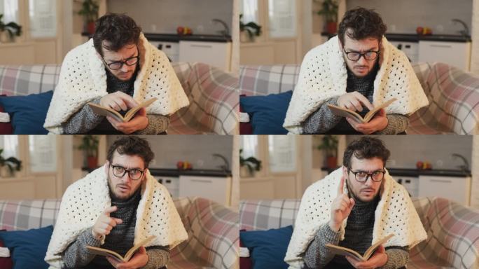 戴眼镜的男人看书，举起手指表示惊讶