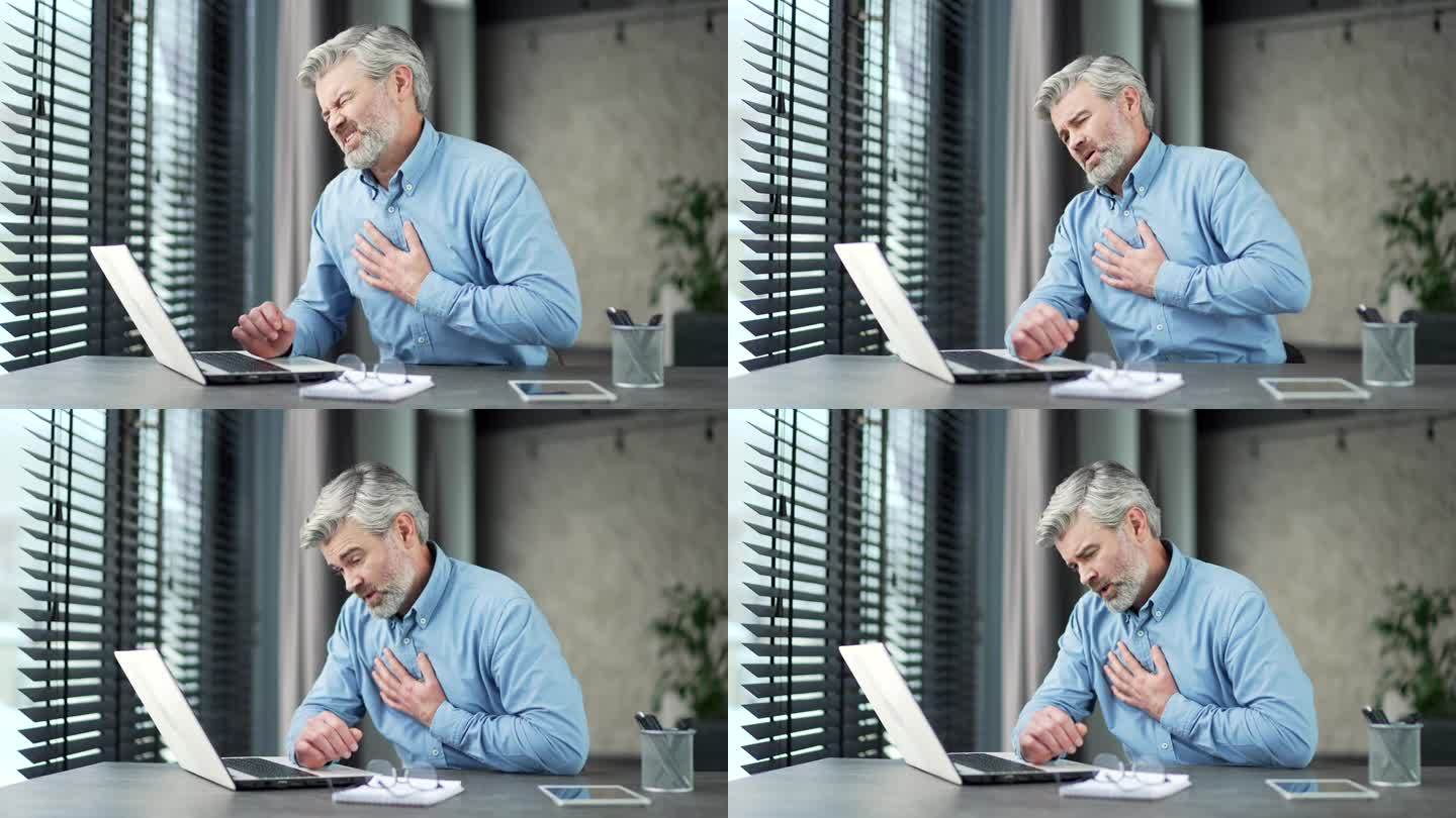 一位白发苍苍、大胡子的成熟商人在办公室用笔记本电脑工作时突发心脏病。