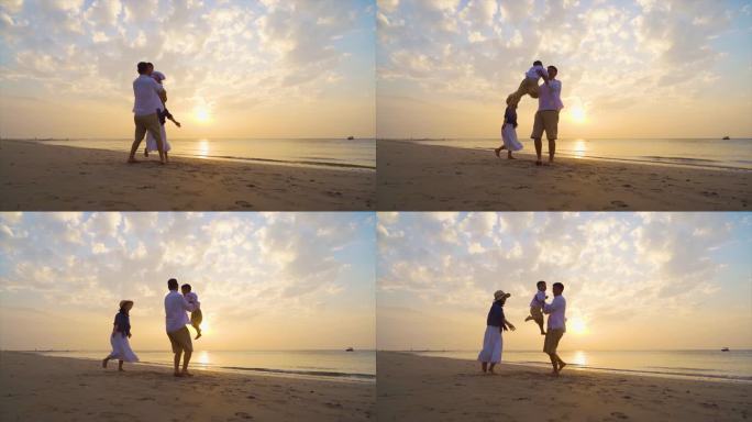 爸爸举起小孩幸福一家三口海边度假欢乐童年