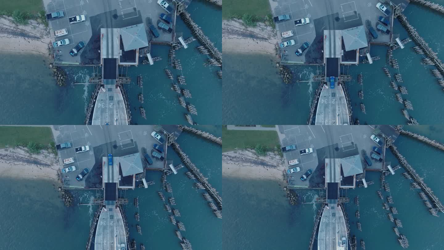 从上到下的无人机拍摄的轮渡在日出前卸载到纽约长岛的庇护岛北福克