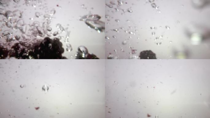 一段微距视频显示黑莓在水中飞溅