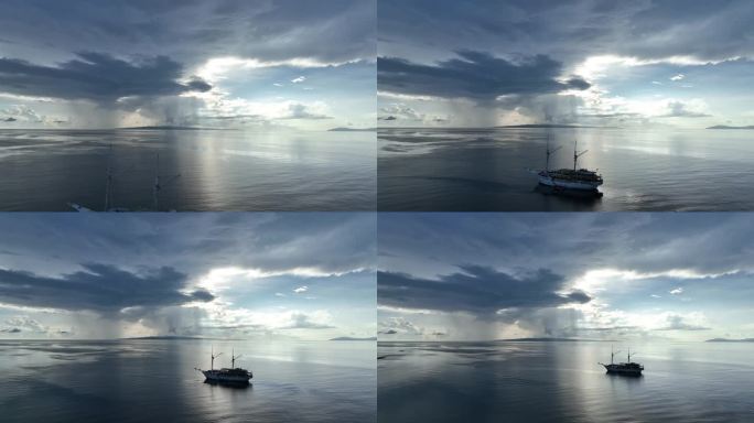 日出时印尼帆船在平静海面上的鸟瞰图