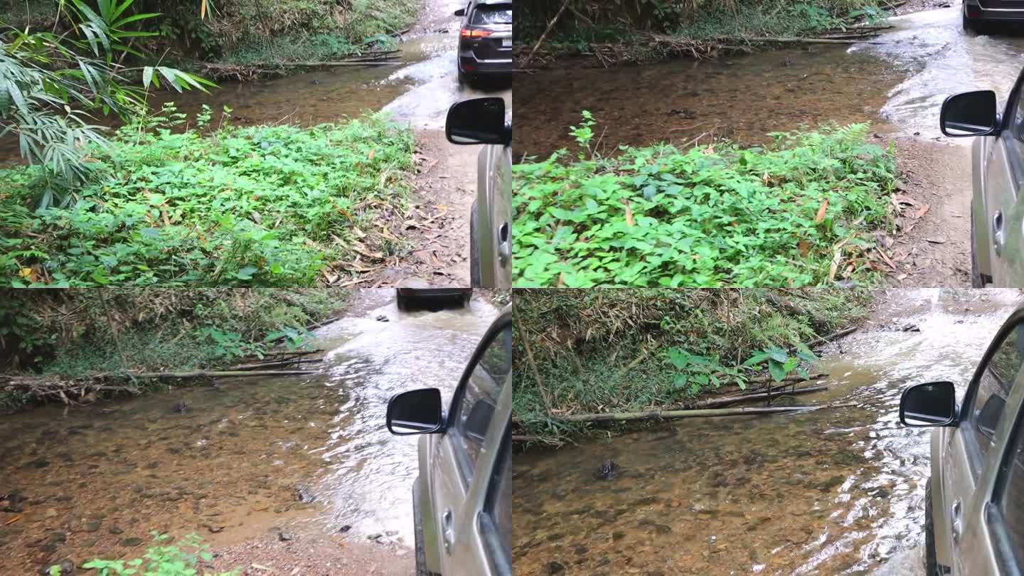 汽车上山经过一条有小溪的自然小路，一条艰难的道路，道路两旁长满了树木。多雨的气氛。观点开车。