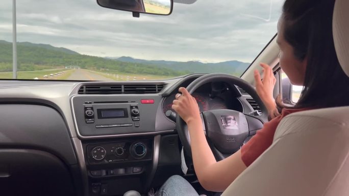 一个女人一边开车一边听音乐。