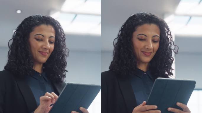 垂直屏幕:女性数据分析师微笑着检查当天的数字平板电脑上的新数据。自信的女商人走向公司大楼里的办公室
