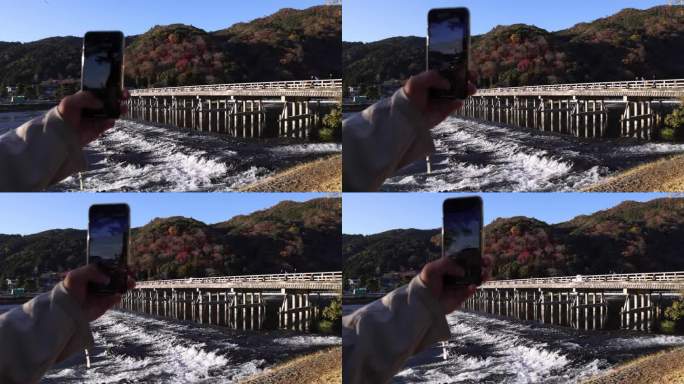 秋天，用智能手机拍摄京都桂川河附近的通津桥