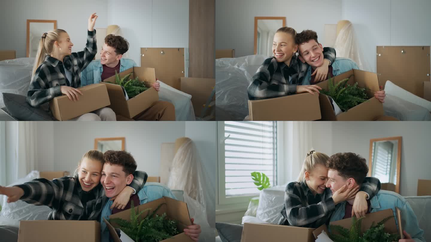 一对兴高采烈的年轻夫妇在他们的新公寓里搬着箱子。移动的概念。