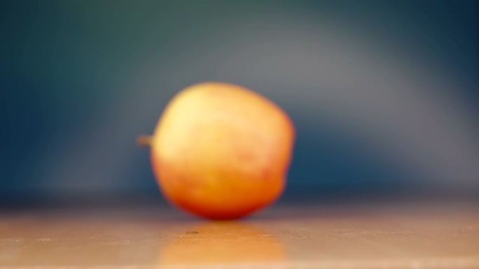 爱沙尼亚木桌上滚动的红苹果