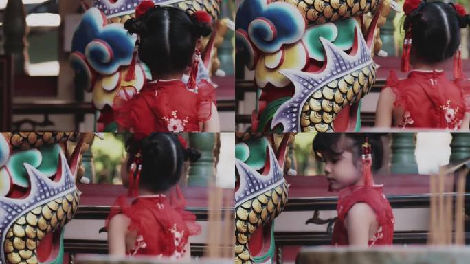 可爱的小女孩在神社里看着龙雕塑