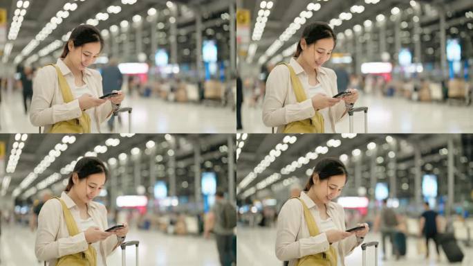 微笑的年轻亚洲女子在机场使用智能手机
