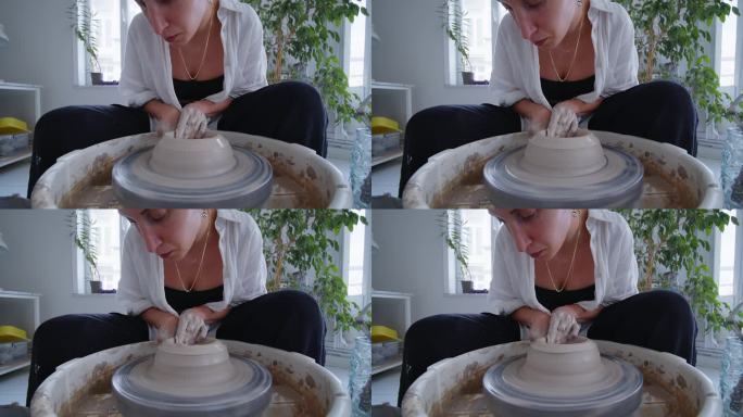 制作优雅与美丽:一位年轻的陶瓷艺术家熟练地在陶轮上塑造了一个粘土花瓶，展示了创造力，工艺，自我表达的