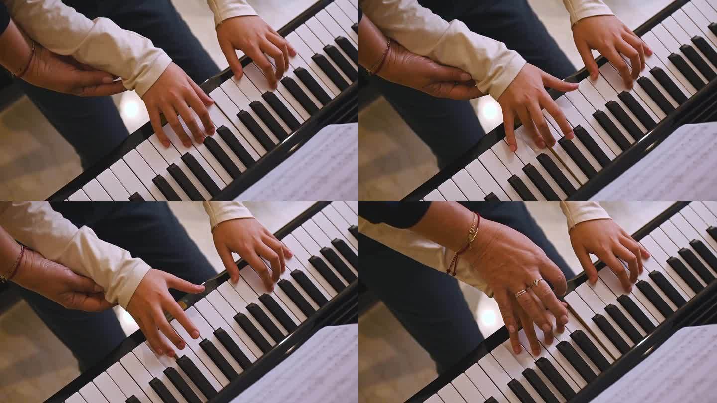 俯视图一位音乐老师，音乐家钢琴家握着一个小男孩的手，给学生上钢琴课