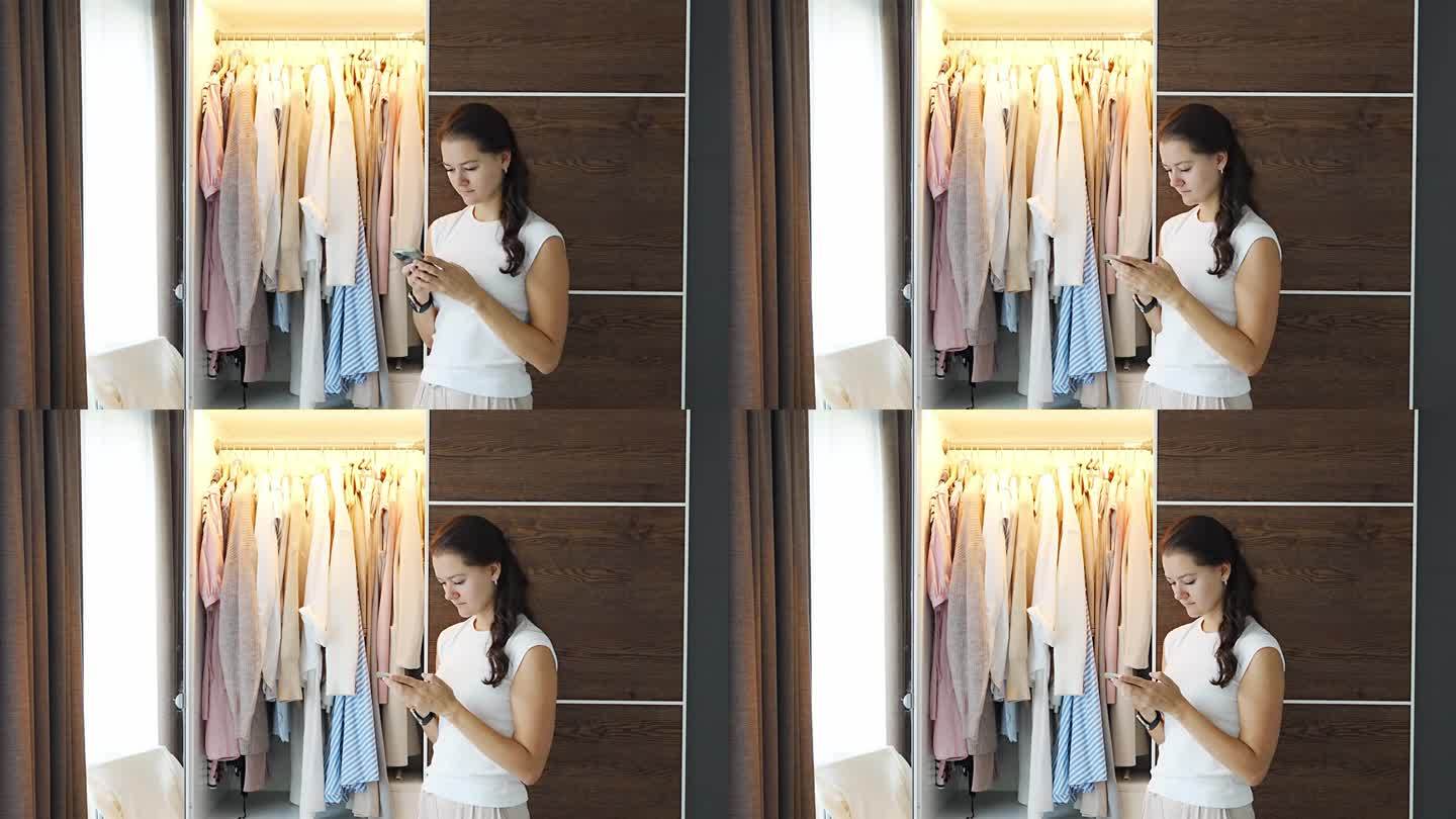年轻女子使用智能手机应用程序出售旧衣服在应用程序。色度绿屏