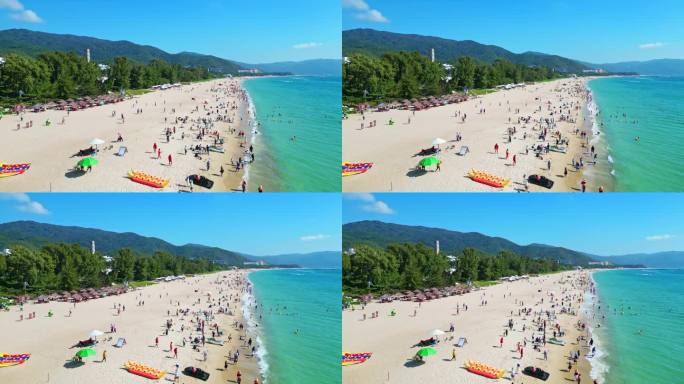 海南三亚亚龙湾航拍蓝天白云海岸线上的游客