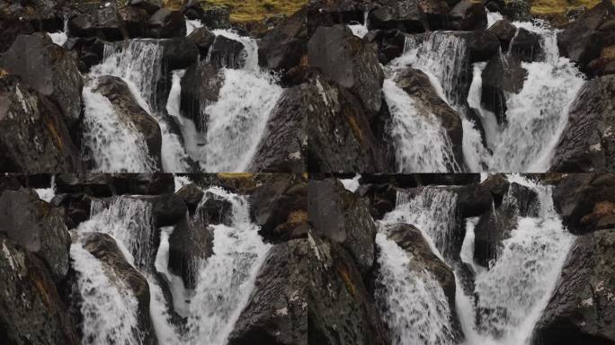 强大的水流穿过深色火山岩，冰岛河流