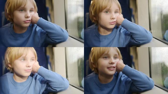 可爱的青春期前男孩在外面下雨的时候坐在地铁车厢或火车上