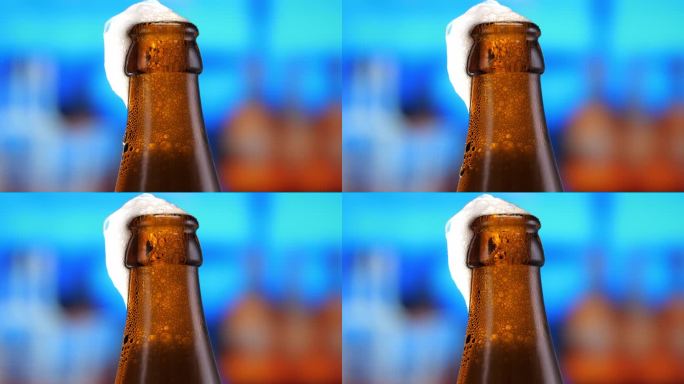 啤酒在啤酒瓶中，形成气泡和泡沫的头部。啤酒泡沫顺着瓶口流下来。特写镜头，微距镜头。啤酒抓住了啤酒节庆