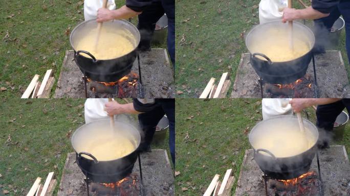 在明火上的大锅中准备玉米粥