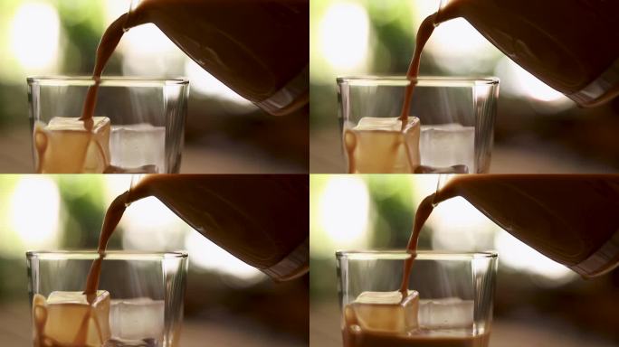 将浓缩咖啡倒入加冰的玻璃杯中。在玻璃杯中加入冰块的现煮咖啡。