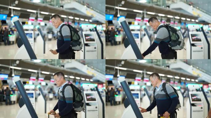 4K亚洲老人在机场候机楼的机器上自助办理登机手续。