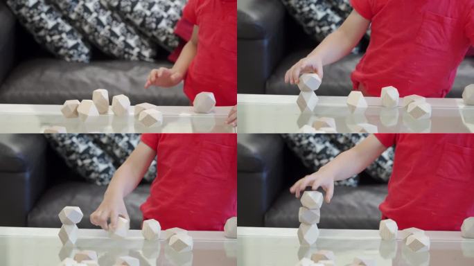 蹒跚学步的小男孩在玩益智玩具土石木石