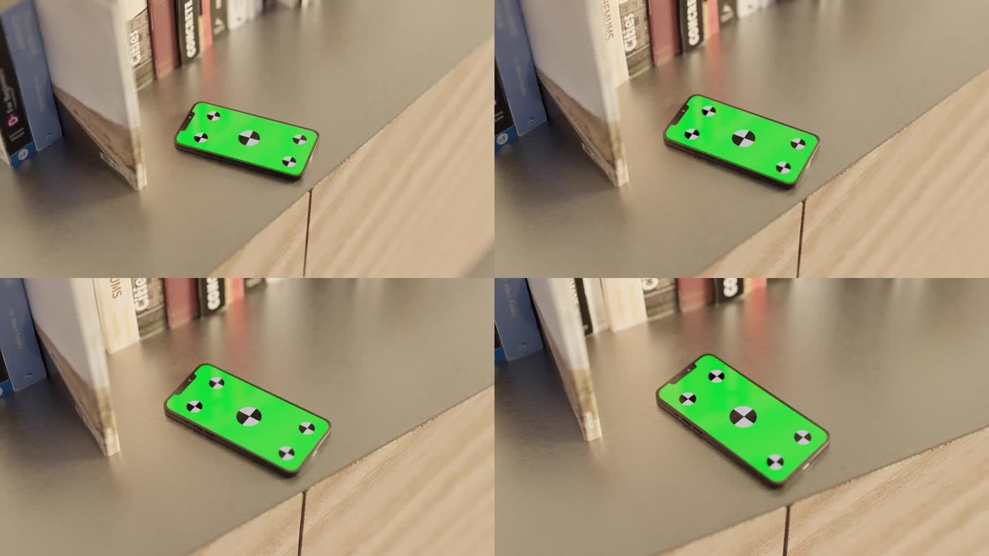 绿色屏幕的智能手机和书放在桌子上