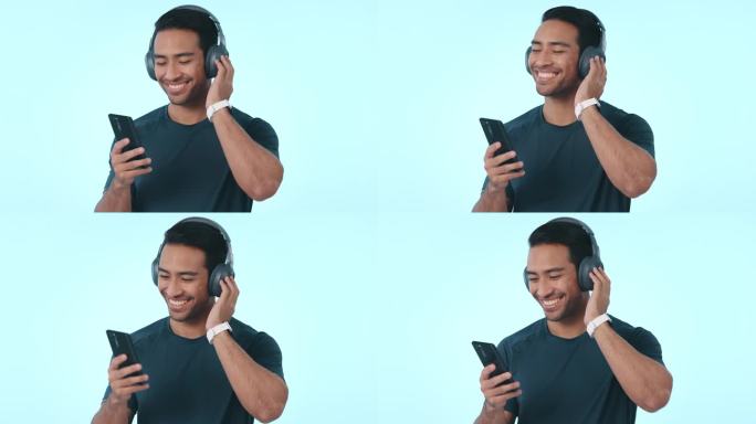 快乐的亚洲人，手机和耳机听音乐或播客在工作室的背景下。男士带着耳机微笑，在智能手机或应用程序上享受音