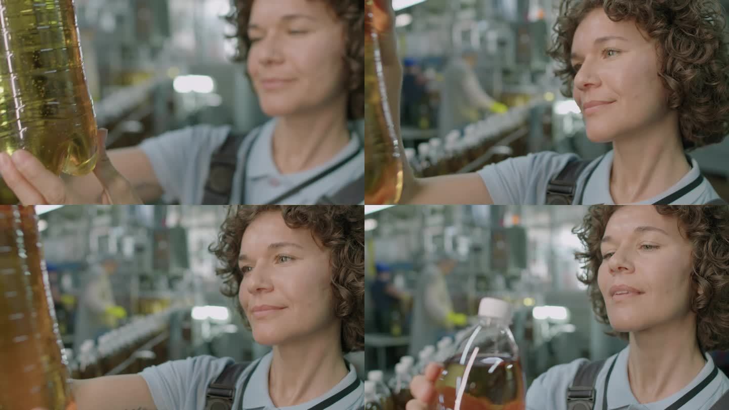工厂工人看着装有柠檬水的塑料瓶