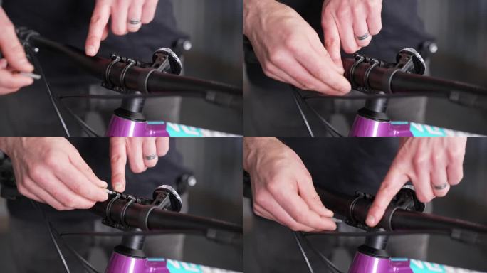 将车把固定在车杆上的过程，由自行车修理工用手轻轻转动螺丝。特写镜头,细节