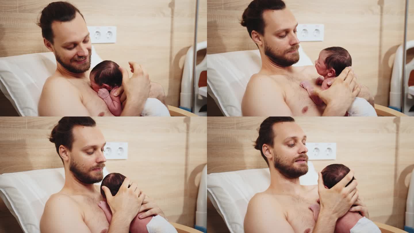 在医院的产后部，可爱的新生男婴在父亲的乳房上照顾他的宝宝，做皮肤对皮肤的特写。父亲坐在医院的扶手椅上