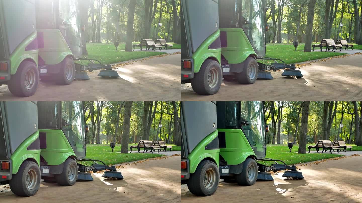 阳光明媚的早晨在城市公园
公共服务部门使用带清洁刷的小型扫地机清洁鹅卵石
城市改善的概念