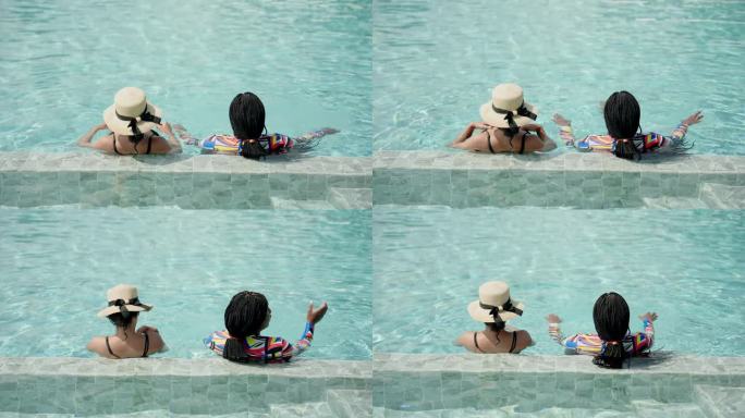 亲密的朋友多民族的人，在游泳池里穿着泳衣。在一个炎热的阳光明媚的日子里，一位美丽的非洲妇女和一位戴着
