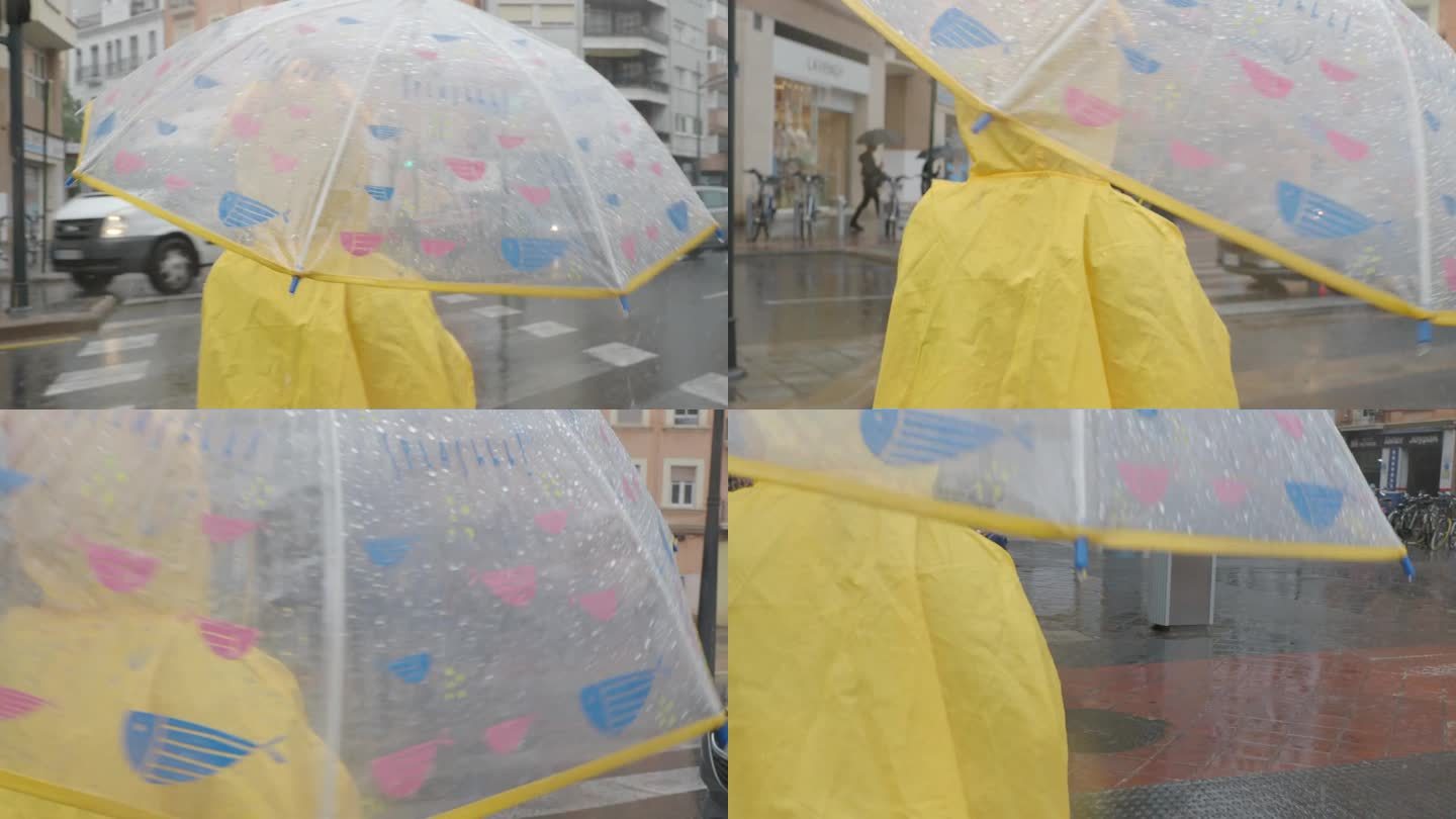伞下穿黄色雨衣的女孩