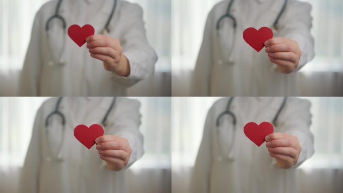 医院里不知名的年轻女医生，穿着白色制服，听诊器拿着红色的小心脏。爱，捐赠，世界心脏日，世界卫生日，企