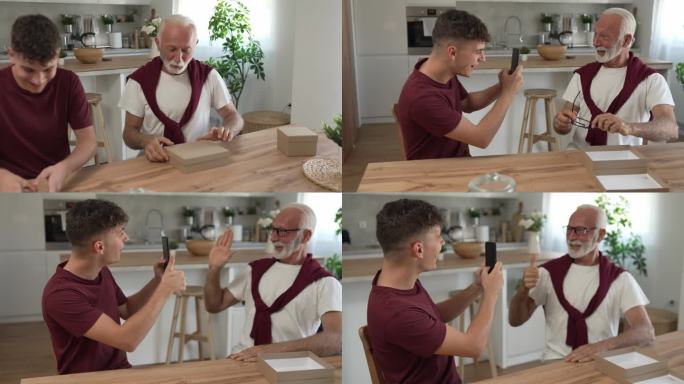 老人爷爷养老金领取者花白的头发和胡子与他的孙子十几岁的男孩收到礼物在盒子里打开快乐的微笑带着眼镜在家