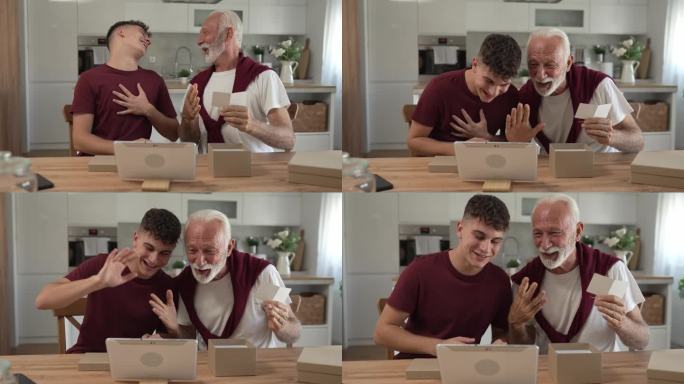 老人爷爷养老金领取者花白的头发和胡子与他的孙子十几岁的男孩收到礼物在盒子里打开阅读卡片快乐的微笑在家