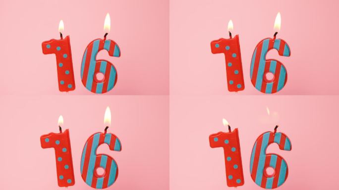 十六周年纪念视频横幅燃烧斑点和条纹红色蜡烛。亮粉色背景上的16号蜡烛。4K分辨率生日快乐横幅