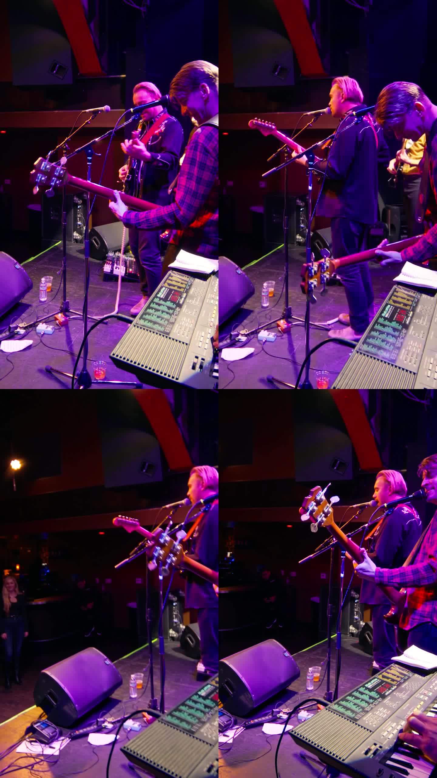 键盘手与乐队在舞台上表演的垂直镜头